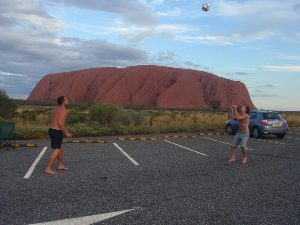 David Simpson and a guy playing soccer near Ayer's Rock in Australia. Rescued in the middle of the desert