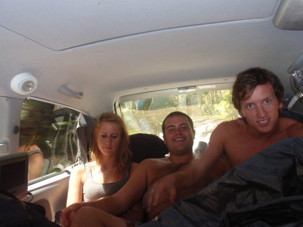David Simpson with a guy and a girl during the road trip in the middle of the desert in Australia. Rescued in the middle of the desert