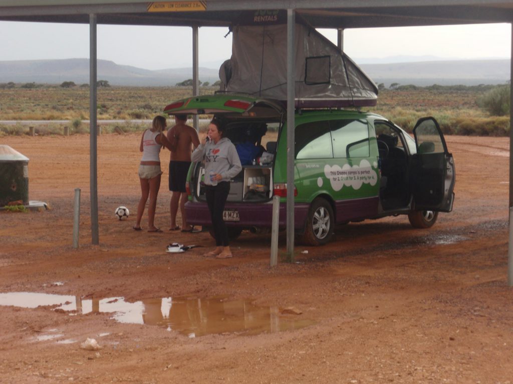 The gang and the green rental car during the road trip in the middle of the desert in Australia. Rescued in the middle of the desert