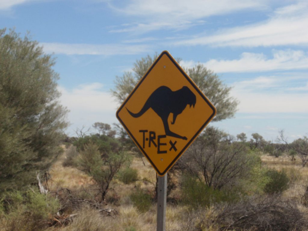 T-rex crossing sign during the road trip in the middle of the desert in Australia. Rescued in the middle of the desert