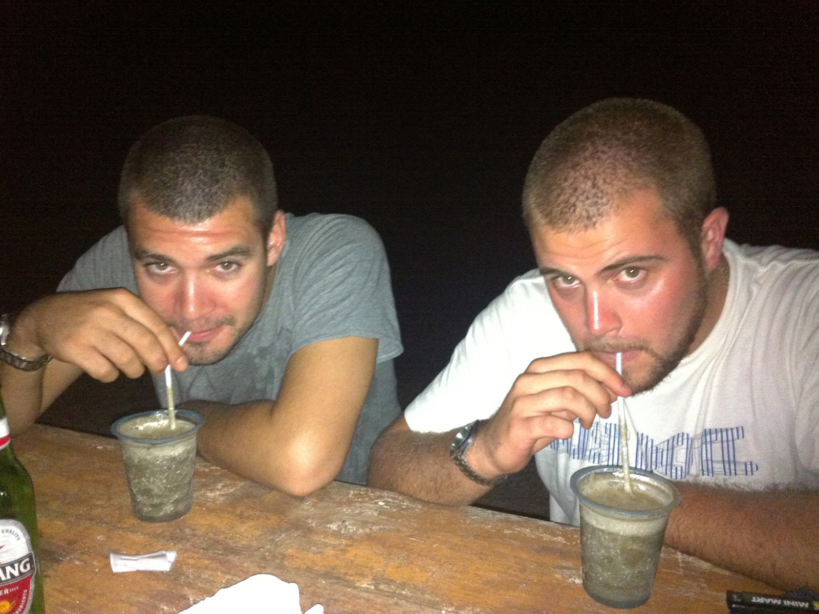 Two guys drinking beer with straw in Gili T. My first taste of Asia