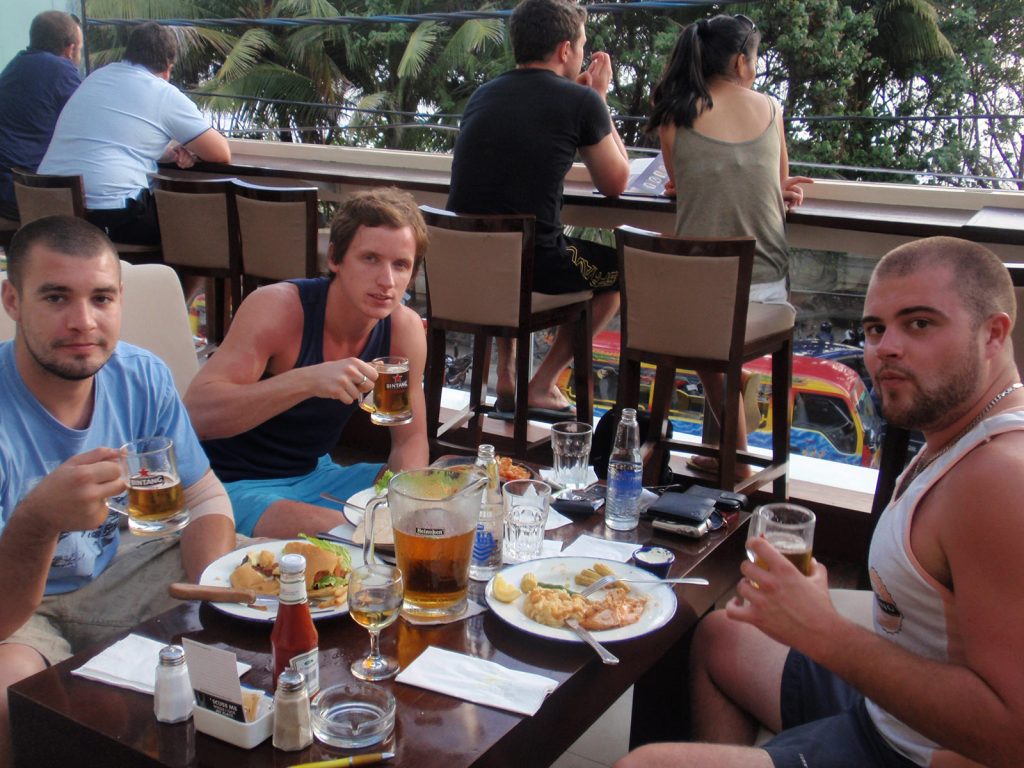 David Simpson with two guys drinking beer in first taste of Asia. My first taste of Asia
