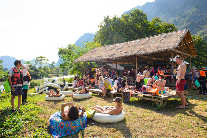 People resting after tubing in Vang Vieng in Laos. Laos most dangerous attraction