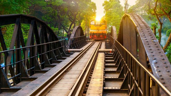 A train passing the bridge over the River Kwai in Bangkok, Thailand. Bridge over the River Kwai and Hellfire Pass