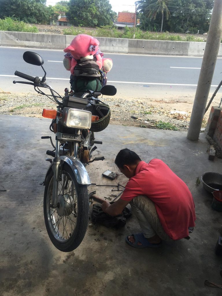 Motorbike being repaired in Da Lat, Vietnam. Night rider and a broken bike