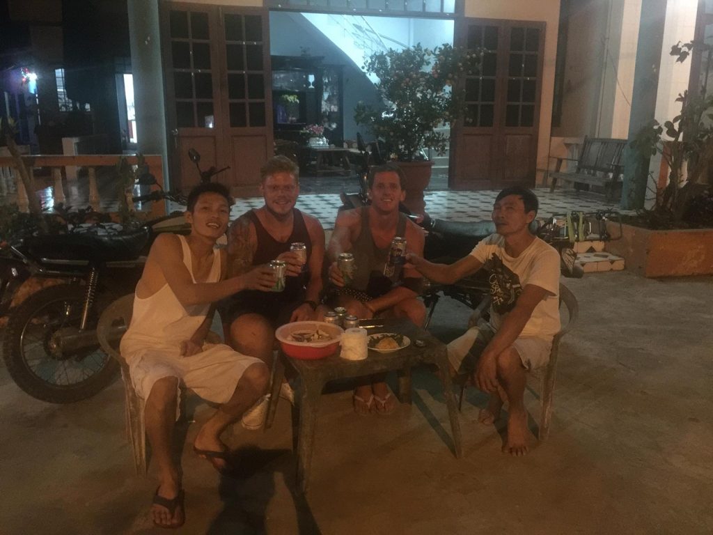 David Simpson and friend drinking with friendly locals in Hue, Vietnam. Crashing twice and friendly locals