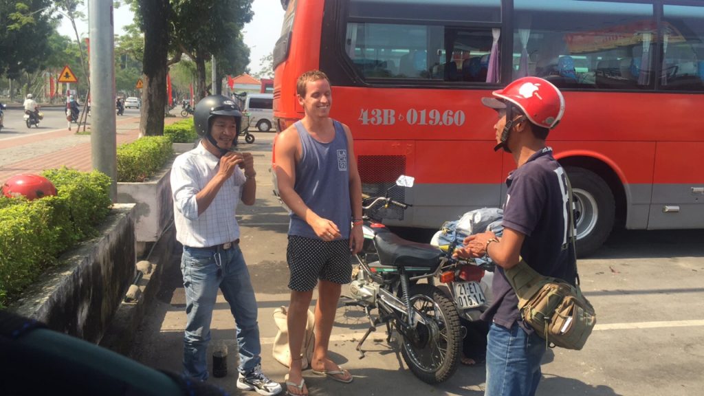 David Simpson with the locals in Hue, Vietnam. Crashing twice and friendly locals