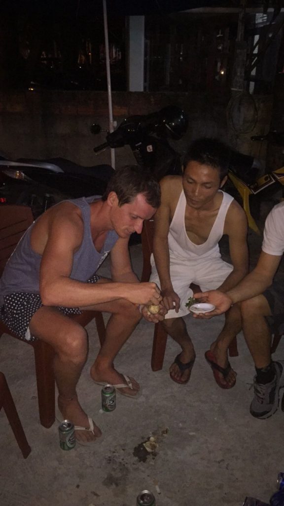 David Simpson and friendly locals eating balut in Hue, Vietnam. Crashing twice and friendly locals