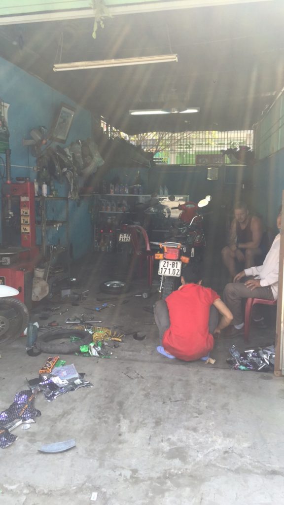 Motorbike repair shop in Hoi An, Vietnam. Hoi Van Pass, Hoi An & a poor man's bag