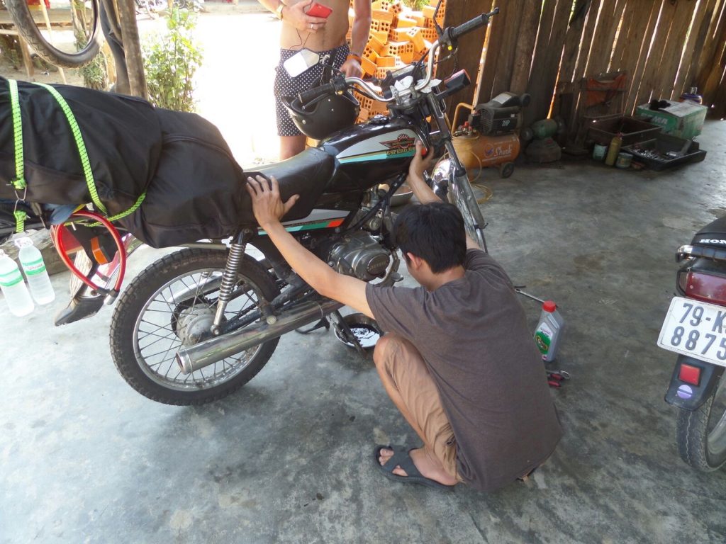 Motorbike mechanic in Hue, Vietnam. Crashing twice and friendly locals