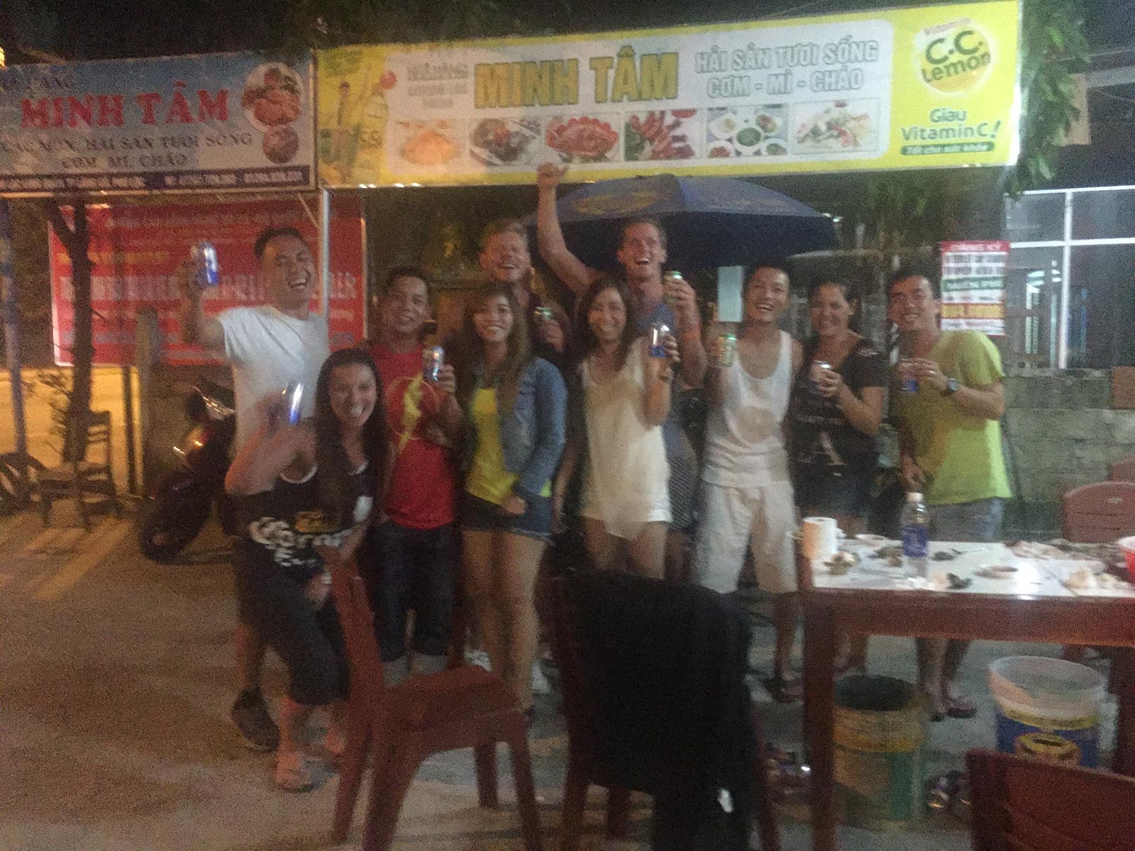David Simpson and friend drinking with friendly locals in Hue, Vietnam. Crashing twice and friendly locals