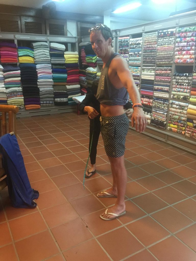 David Simpson being measured by a tailor in Hoi An, Vietnam. Hoi Van Pass, Hoi An & a poor man's bag
