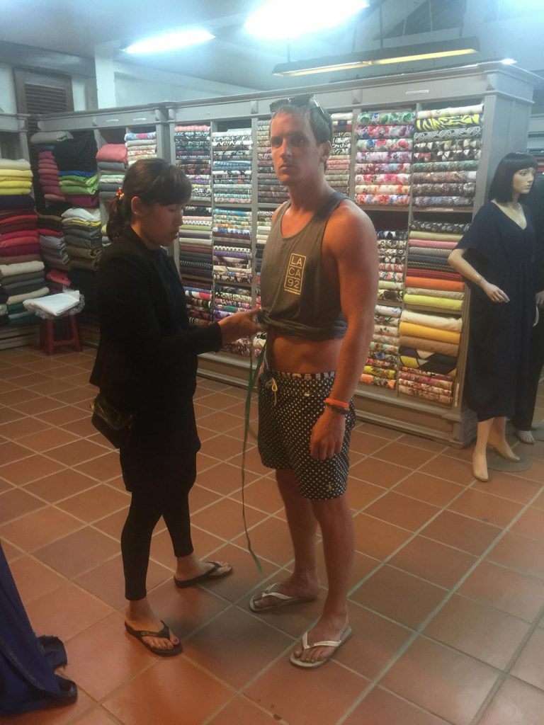 David Simpson being measured by a tailor in Hoi An, Vietnam. Hoi Van Pass, Hoi An & a poor man's bag