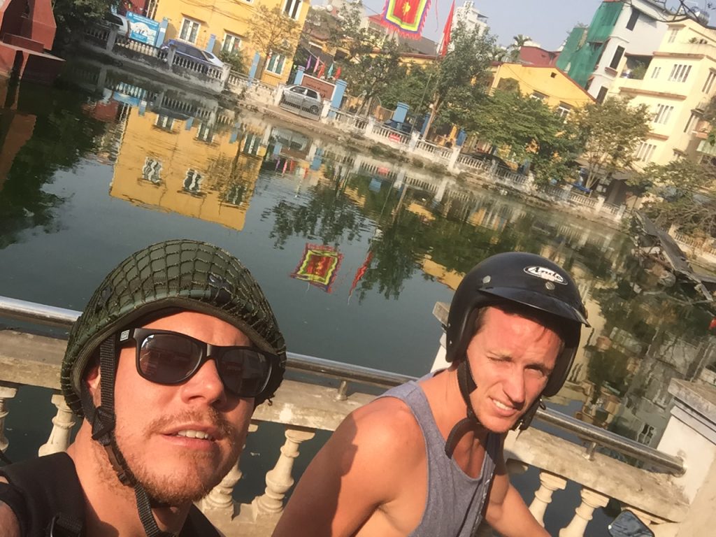 David Simpson and a friend by the river in Hanoi, Vietnam. Buying bikes and checking out Hanoi