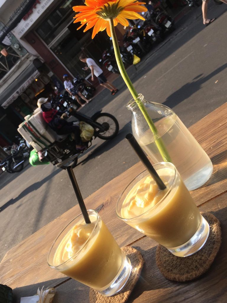 Mango smoothie and flower in Saigon, Vietnam. Stabbings & tunnels in Ho Chi Minh