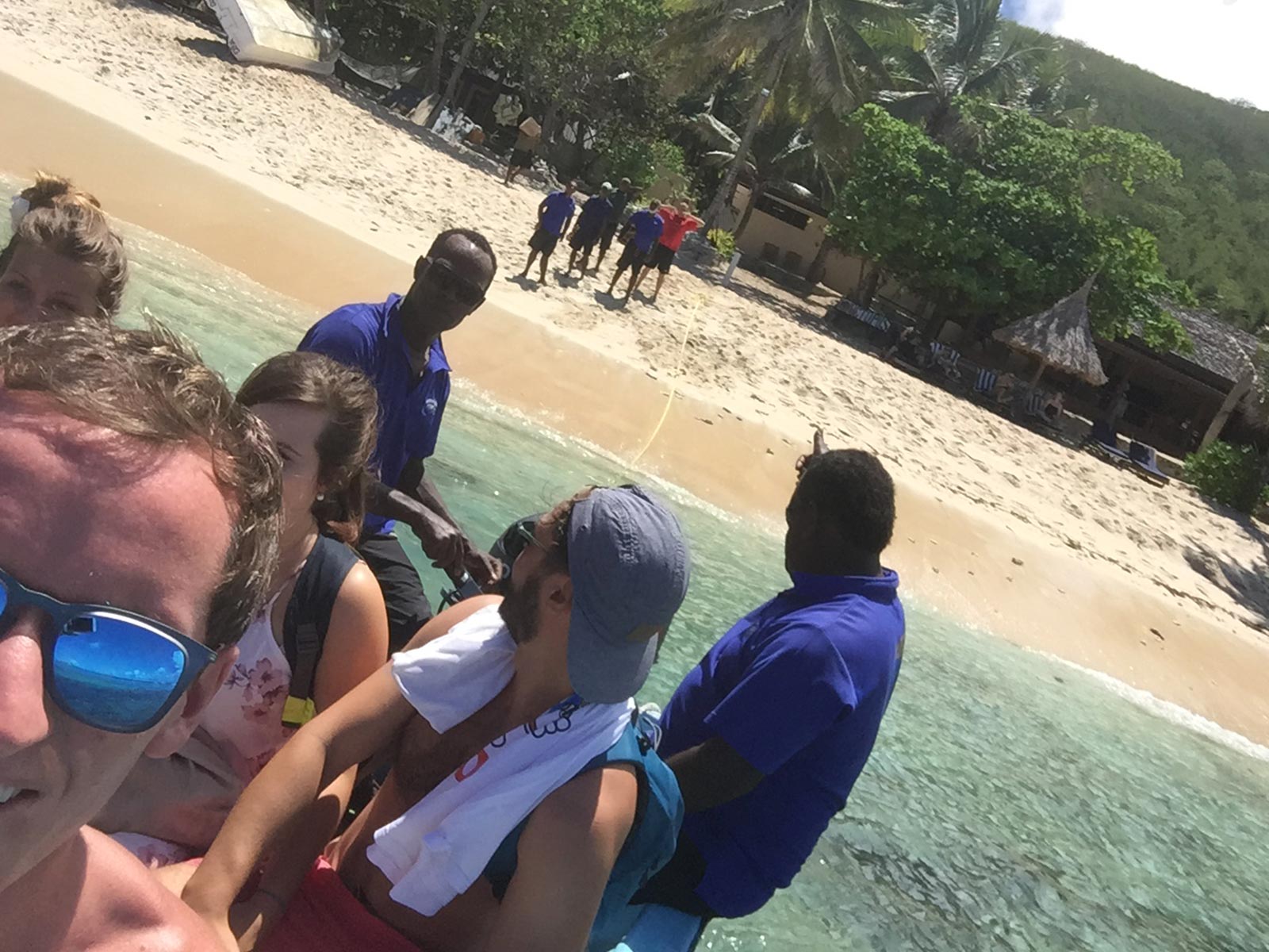 David Simpson with friends on a boat near the beach at Mantaray Island, Fiji. More party games at Mantaray Island