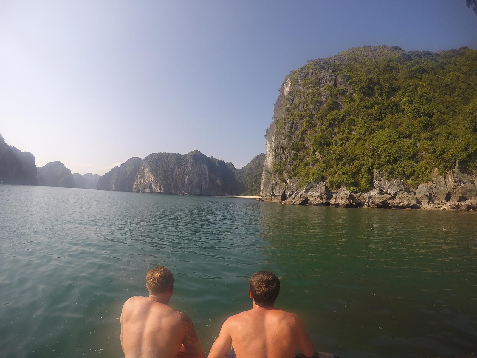 David Simpson and friend on a boat in Ha Long Bay, Vietnnam. Rock climbing in Ha Long Bay