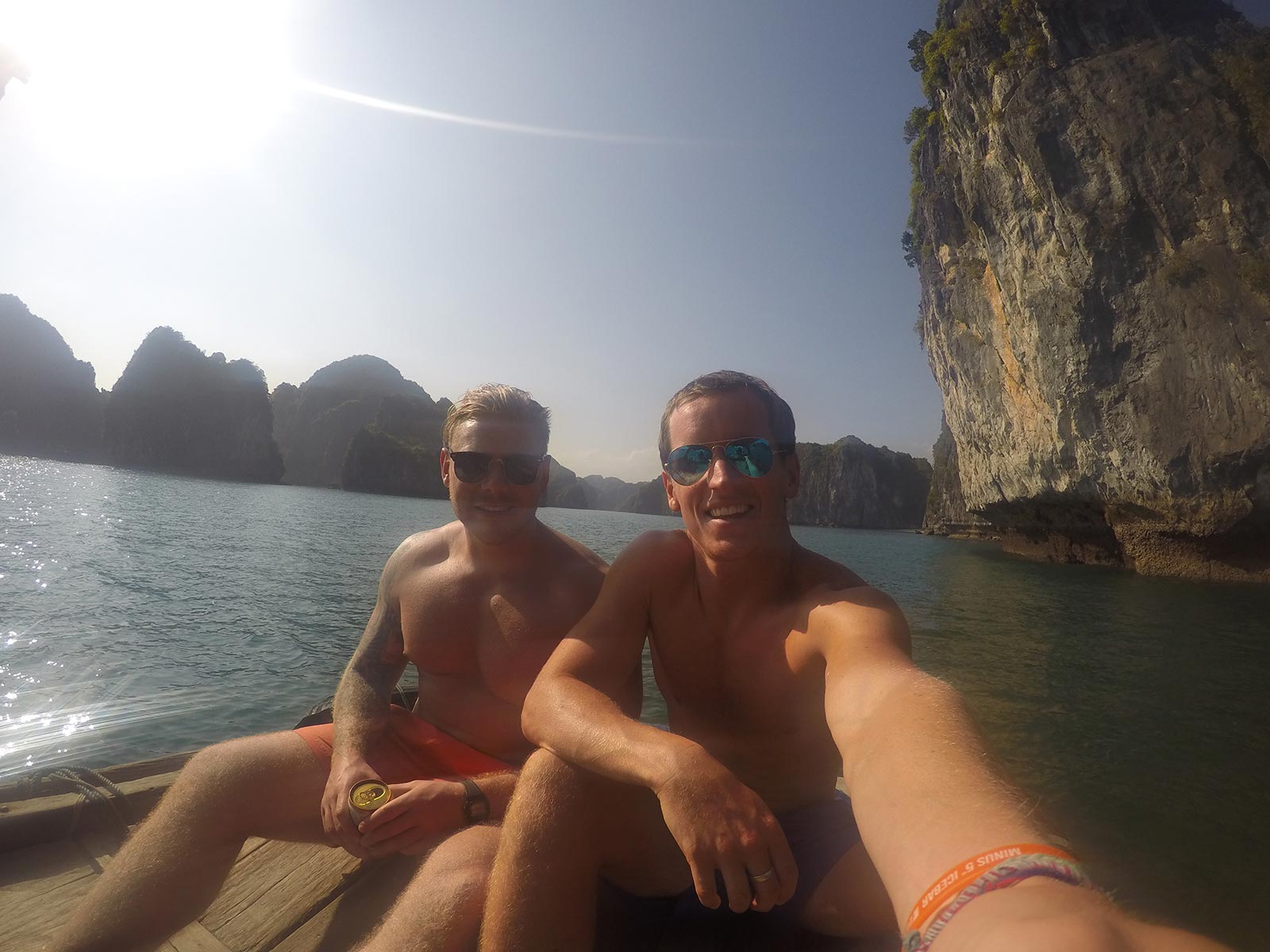 David Simpson and friend on a boat in Ha Long Bay, Vietnam. Rock climbing in Ha Long Bay