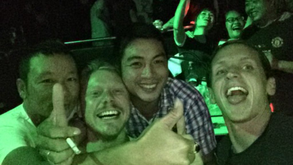 David Simpson and a friend with locals at a club in Quy Nhon, Vietnam. The Vietnamese clubs