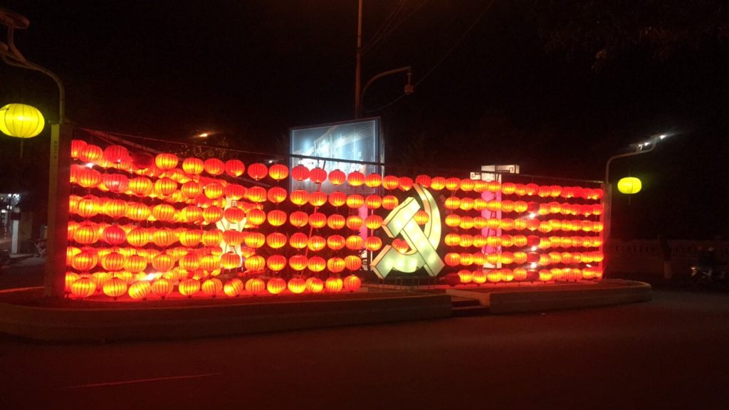 Communist symbol lighted at night in Quy Nhon, Vietnam. The Vietnamese clubs