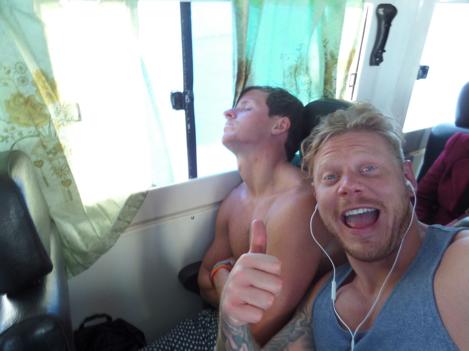 David Simpson asleep and a friend seated on a bus in Ha Long Bay, Vietnam. Wake boarding and back to Hanoi