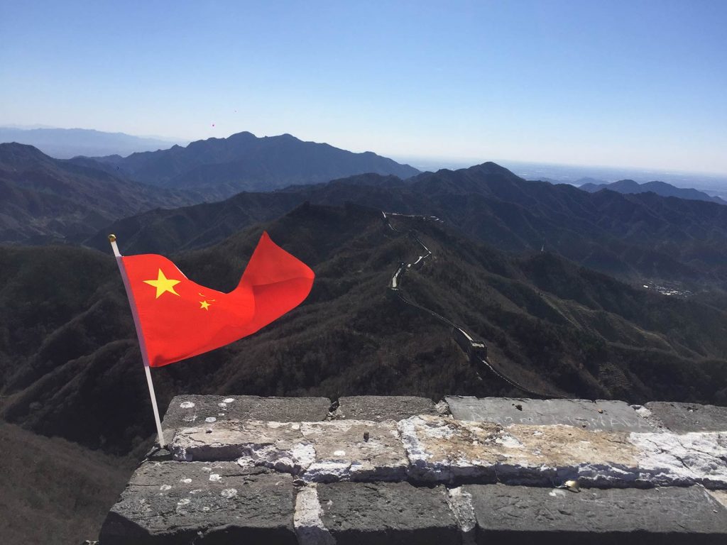 Chinese flag at the Great Wall of China in Beijing, China. The Great Wall of China