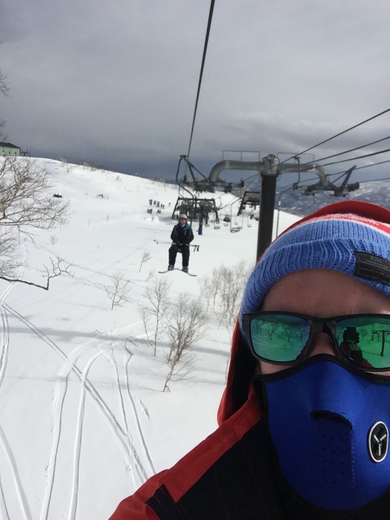 David Simpson riding the ski lift with family in Niseko, Japan. Skiing & Snowmobiles in Niseko, Japan