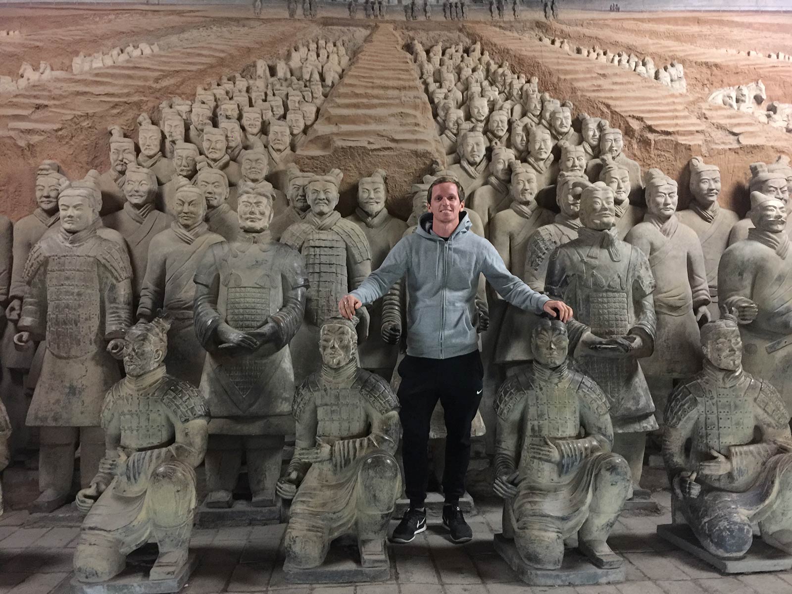 David Simpson standing with the terracotta warriors in Xi'an, China. The terracotta warriors