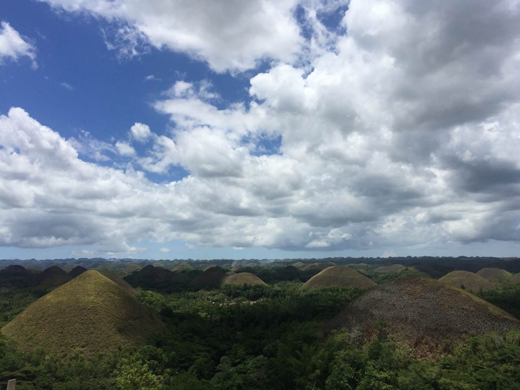 Clouds over Chocolate Hills in Bohol, Philippines. Alona Beach & Chocolate Hills
