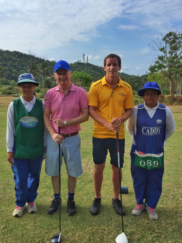 David Simpson and dad with local caddies at golf course in Boracay, Philippines. A week at the Shangri-La Resort, Boracay