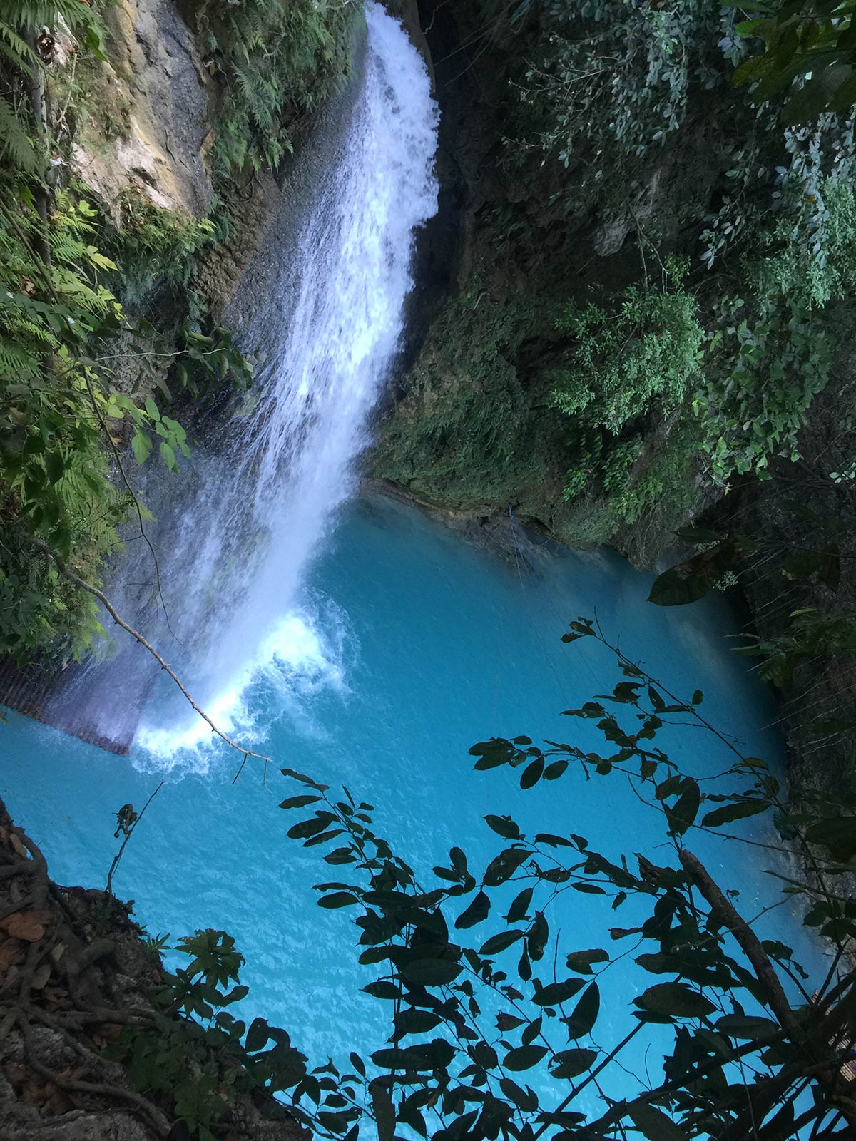 Waterfall with blue waters in Moalboal, Philippines. Canyoneering in Moalboal