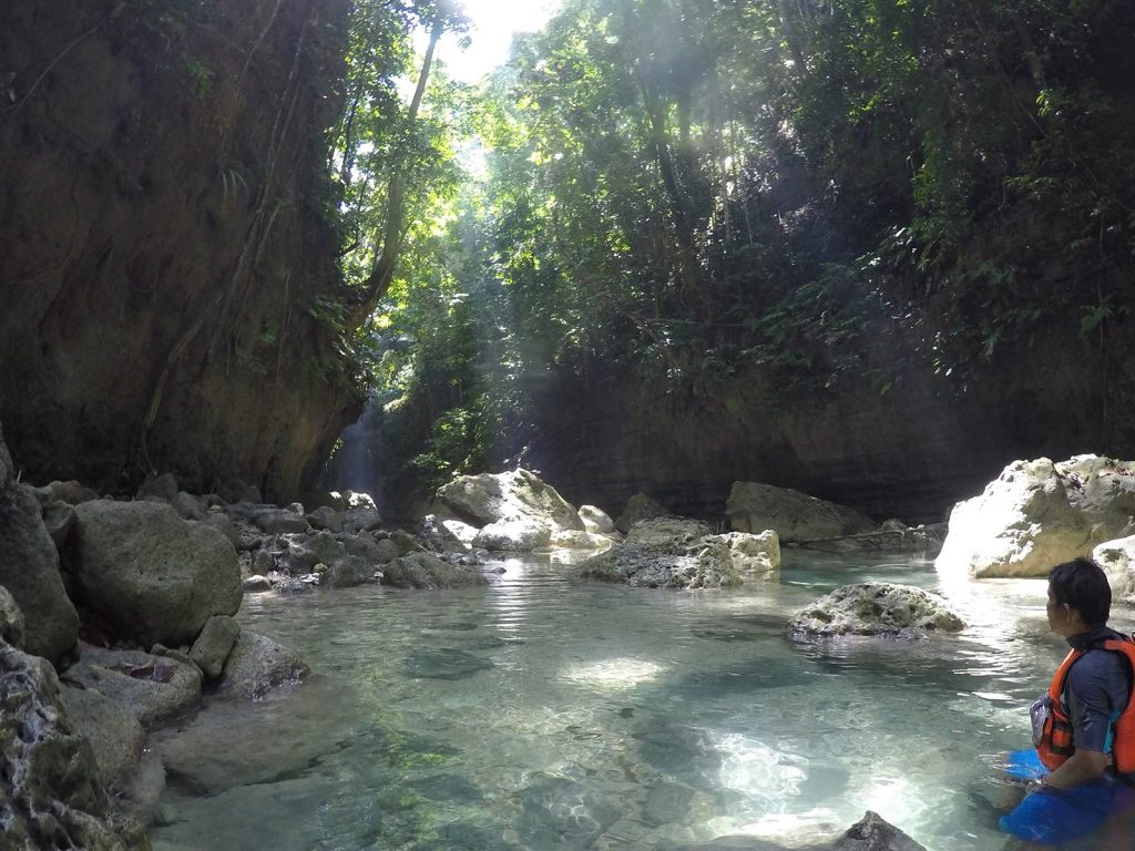 Rocky river surrounded by trees in Moalboal, Philippines. Canyoneering in Moalboal