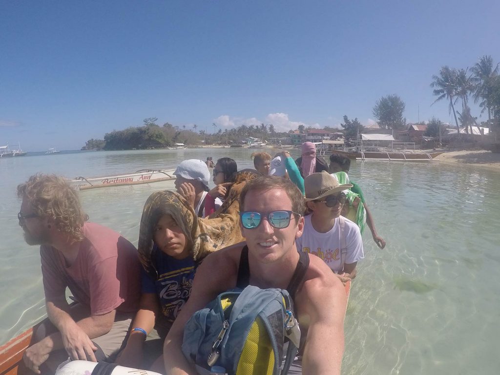 David Simpson riding with a boatload of passengers in Malapascua, Philippines. Diving with sharks in Malapascua