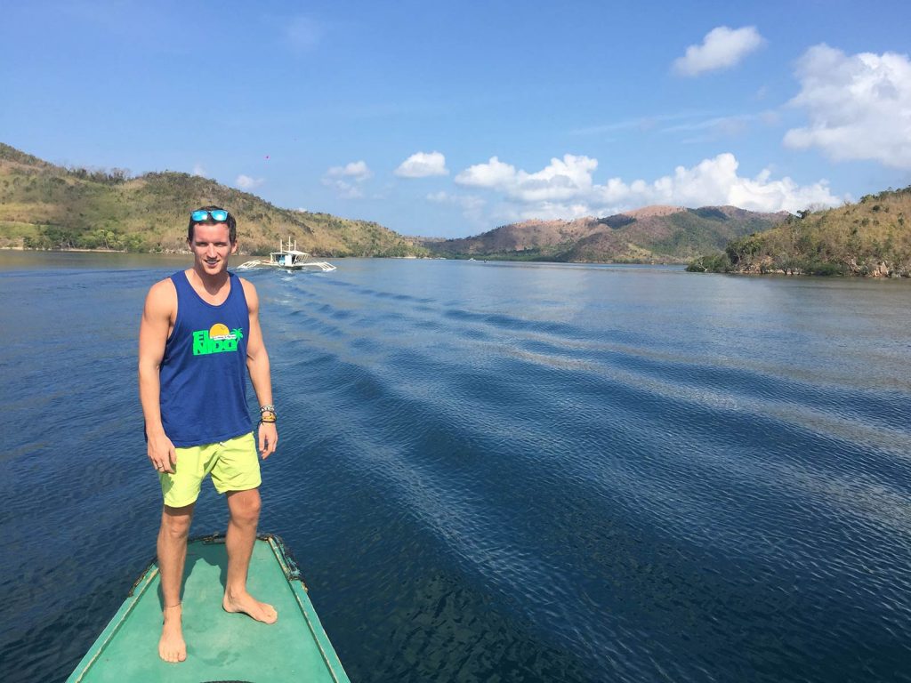David Simpson on a boat at Twin Lagoon in Coron, Philippines. Diving shipwrecks & stunning lagoons in Coron