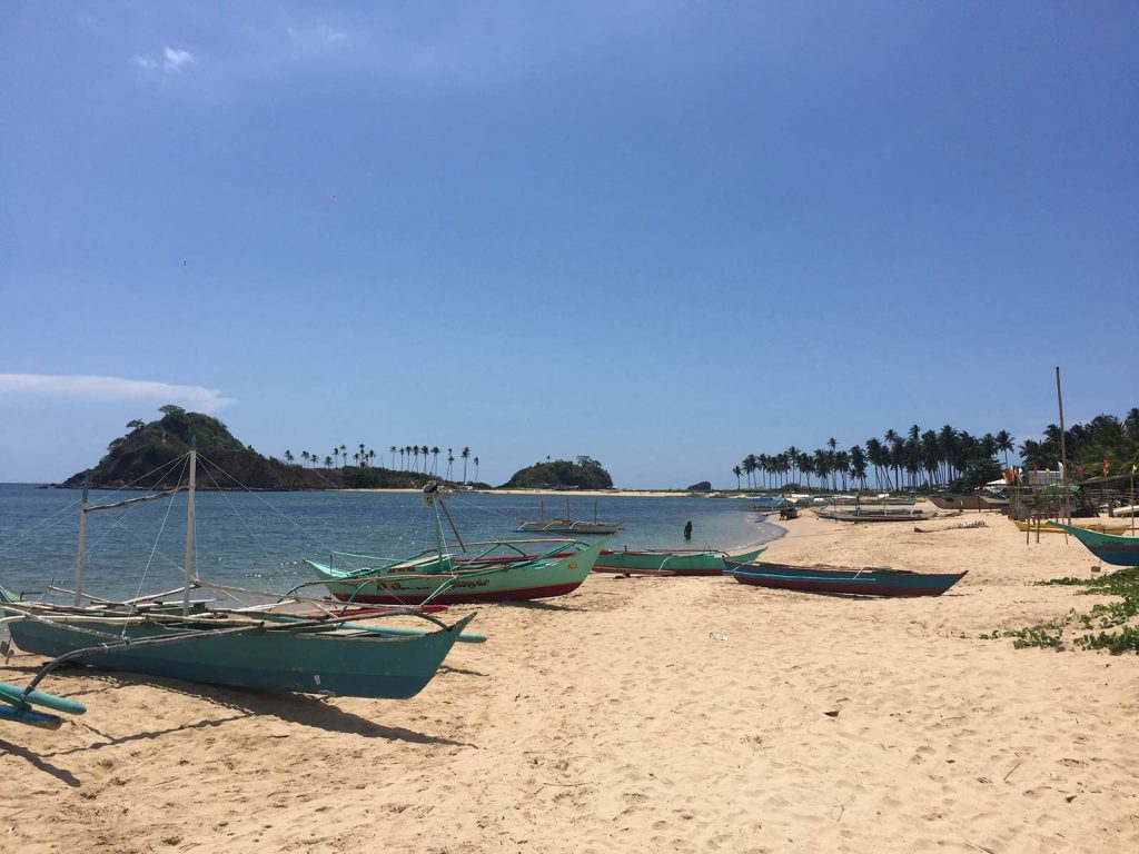 Fishing boats by the beach in Nacpan, Philippines. The best beach in the world all to myself
