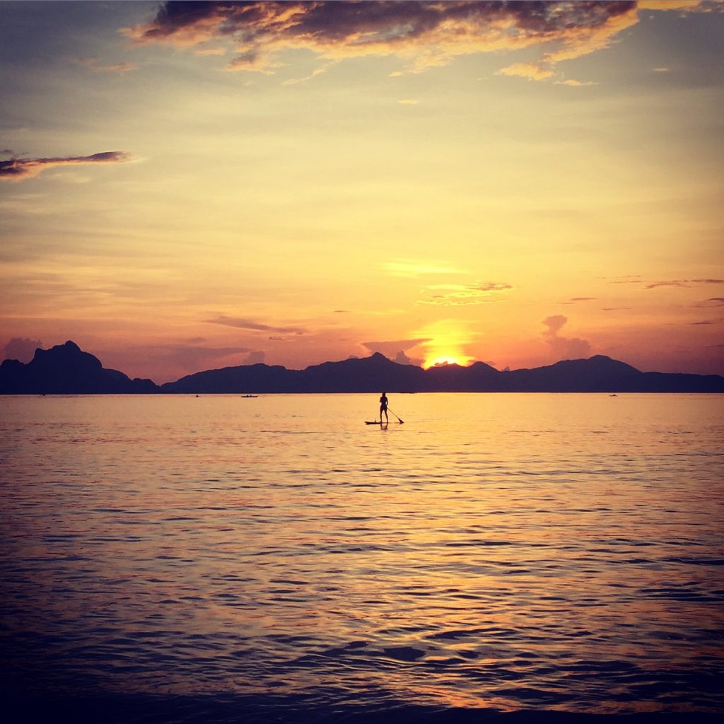 Paddle boarding at sunset by the beach in Nacpan, Philippines. The best beach in the world all to myself