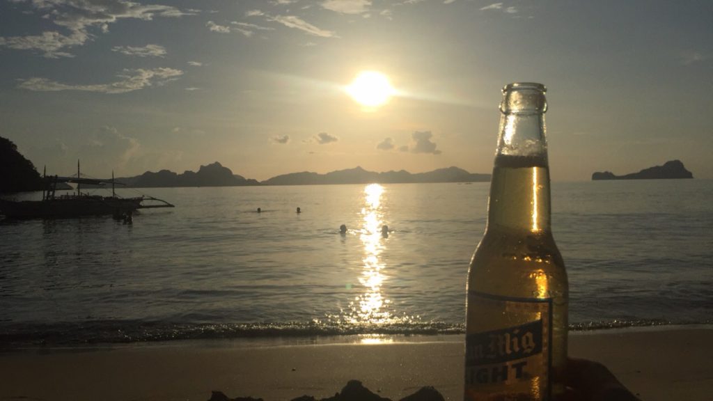 Sunset by the beach and bottle of San Mig Light in Nacpan, Philippines. The best beach in the world all to myself