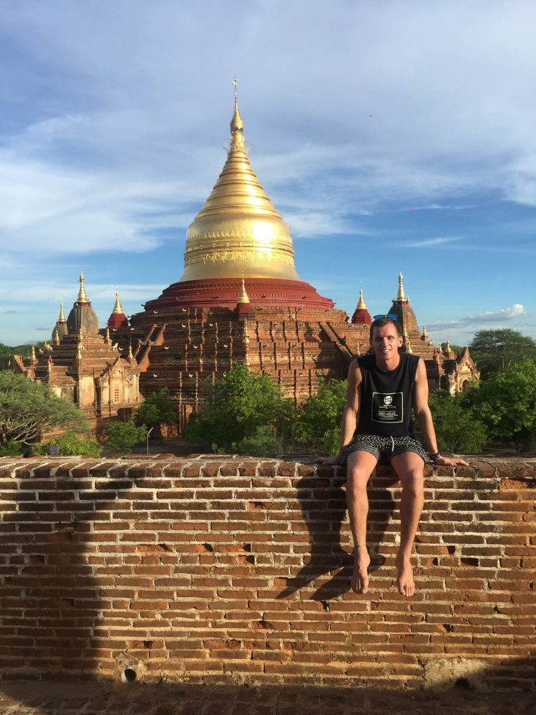 David Simpson seated by a temple with golden spire in Bagan, Myanmar. Trains, temples & Bagan, The highlights of Myanmar