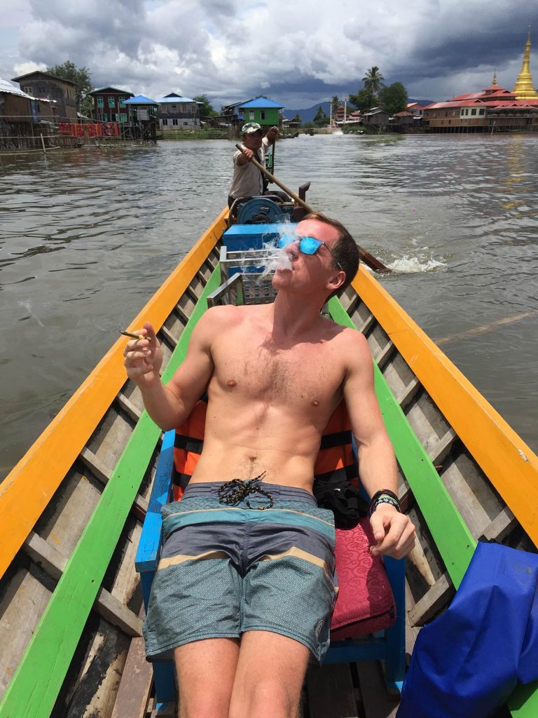 David Simpson smoking on a boat in Inle Lake, Myanmar. Trains, temples & Bagan, The highlights of Myanmar