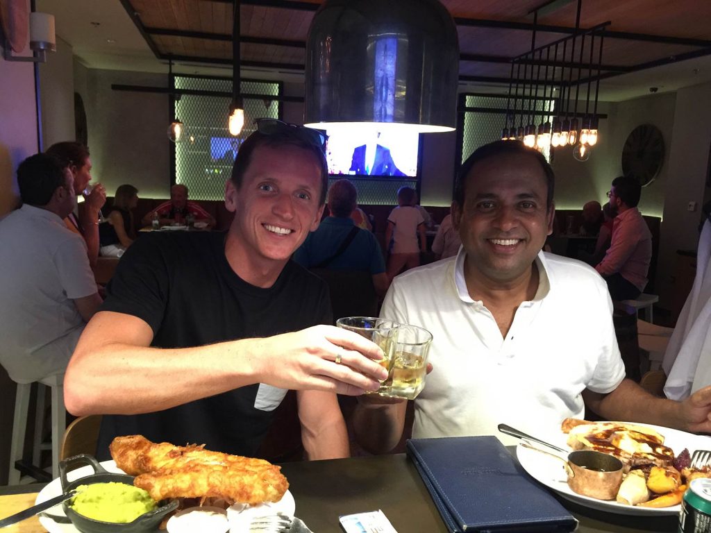 David Simpson and friend eating dinner in Dubai, UAE. Safaris in Dubai & waffles in Brussels