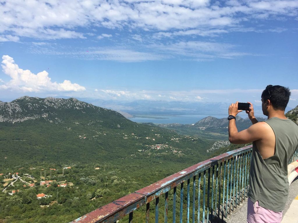 Man taking photo of mountain view in Kotor, Montenegro. My Balkans trip summed up in photos