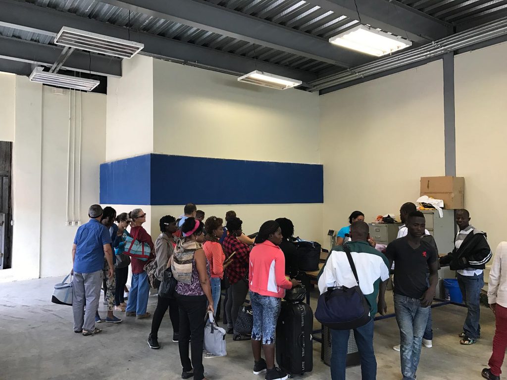 People crossing border passing thru customs at Dominican Republic. Haiti & Dominican Republic, an Island of two halves