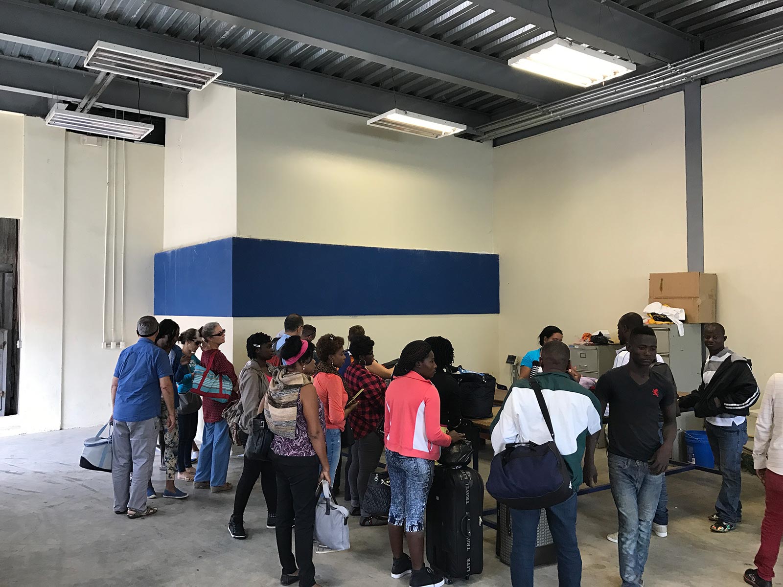 People crossing border passing customs in Dominican Republic. Haiti & Dominican Republic, an Island of two halves