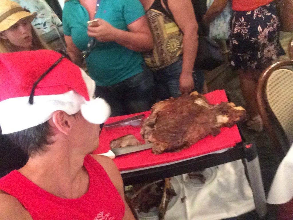 David SImpson and friends looking at the roasted ribs in Rio de Janeiro, Brazil. Friends, steak & Copacabana, a perfect Christmas in Rio