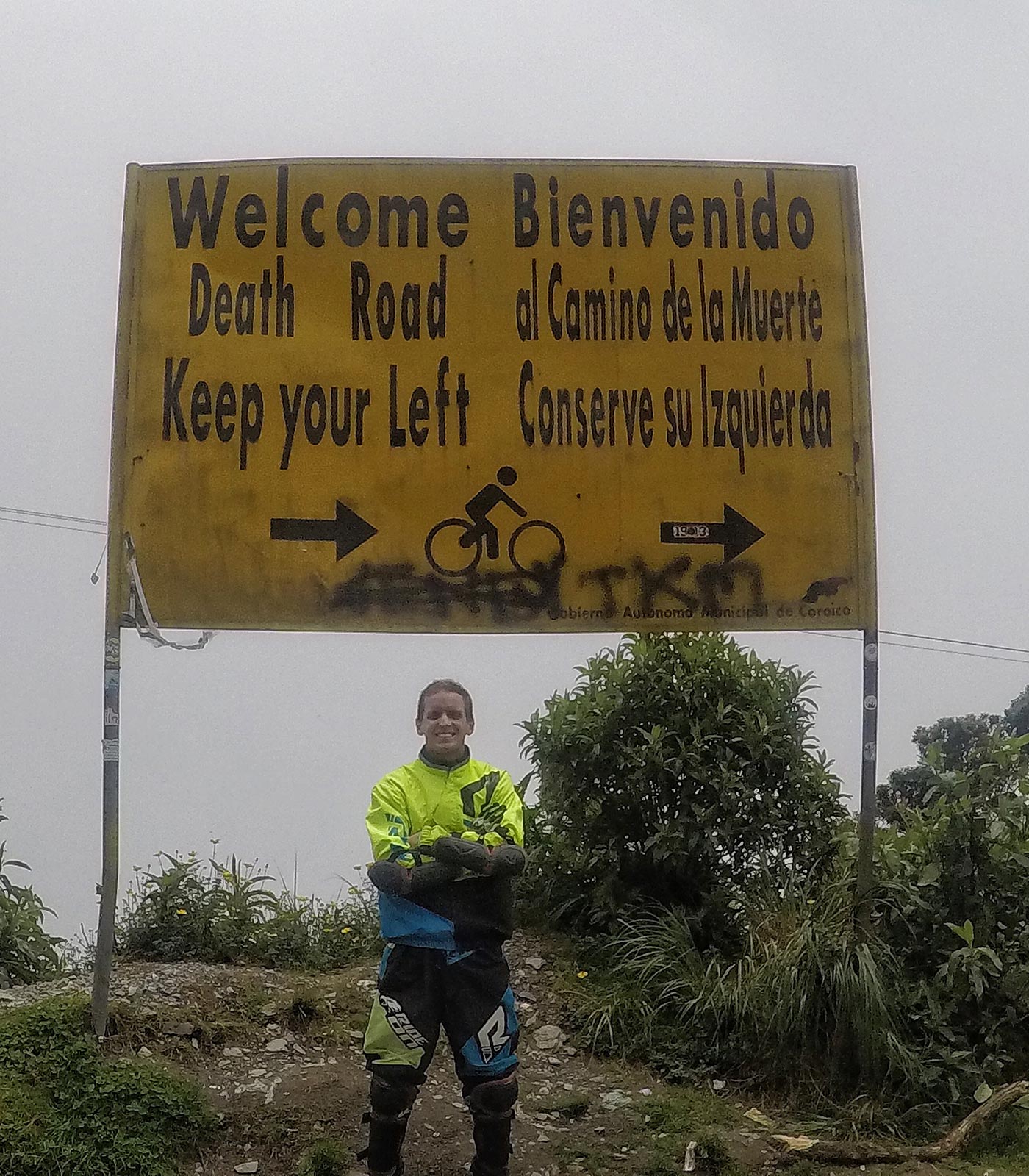 David Simpson standing by the Death Road sign in Bolivia. Cycling Death Road & Full Guide