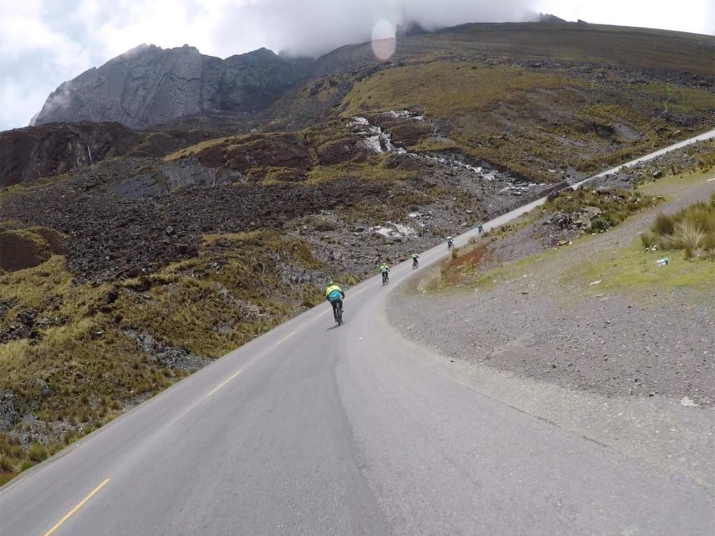 Cyclists cycling Death Road in Bolivia. Cycling Death Road & Full Guide