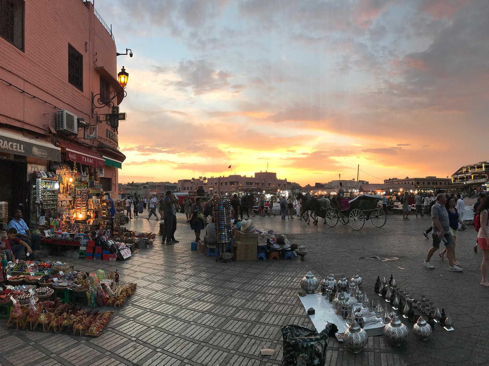 Market at sunset in Marrakesh, Morocco. Being attacked by a man with a snake