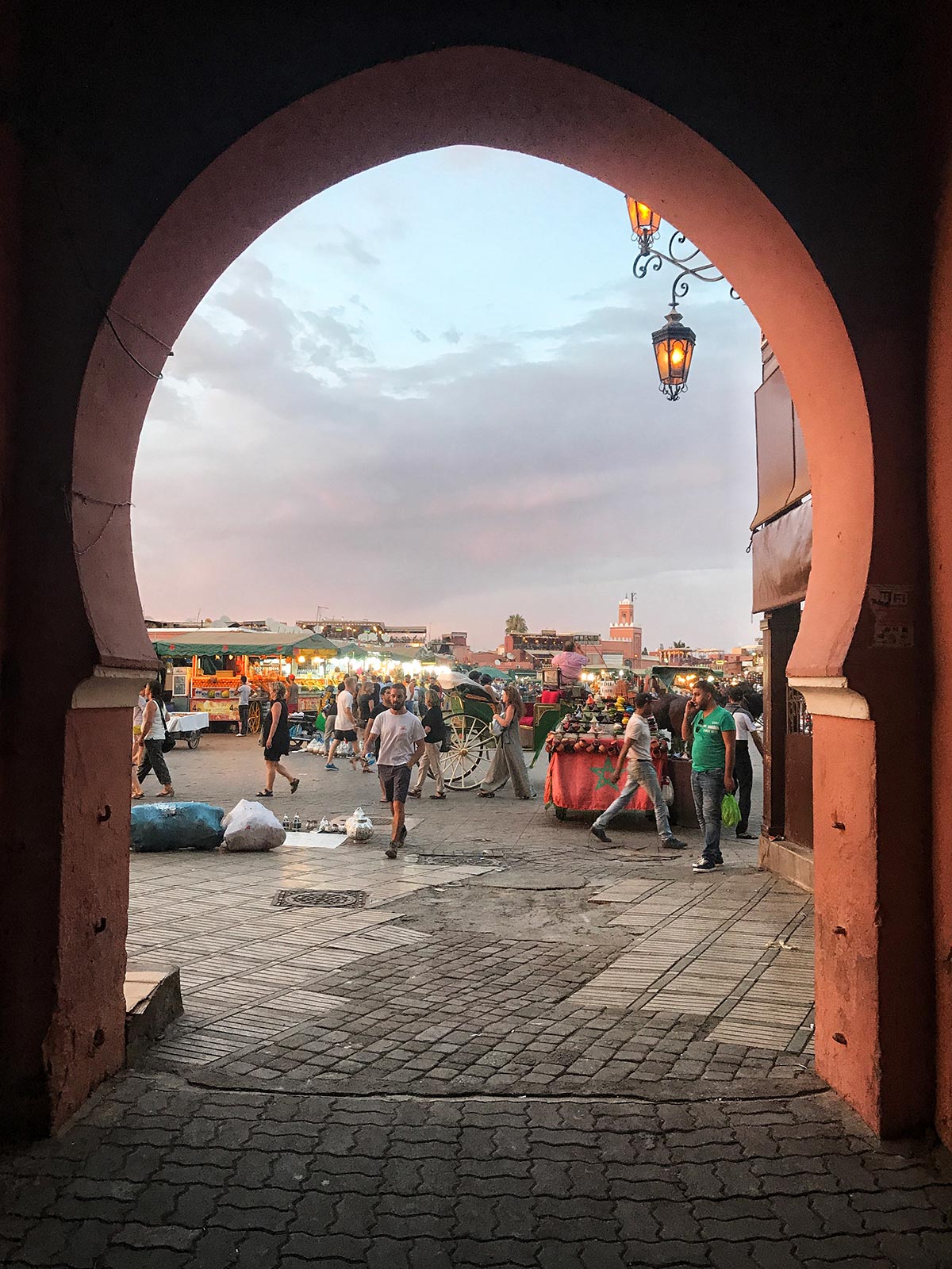 Sunset at the market in Marrakesh, Morocco. Being attacked by a man with a snake