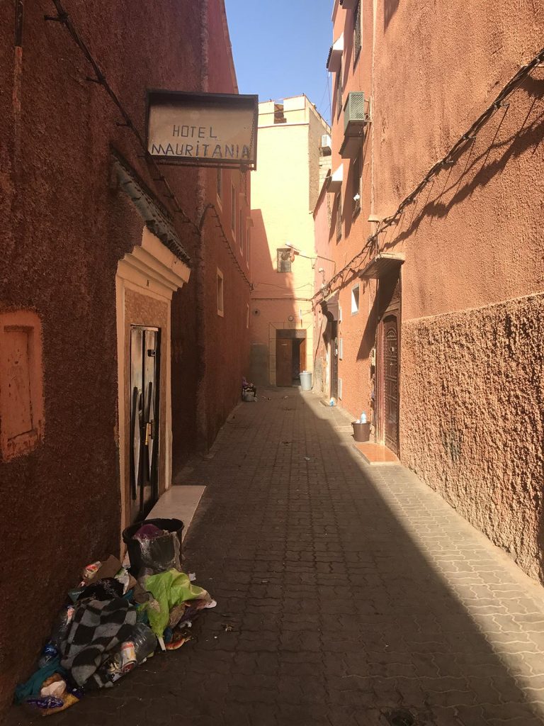 Neighborhood in Marrakesh, Morocco. Being attacked by a man with a snake
