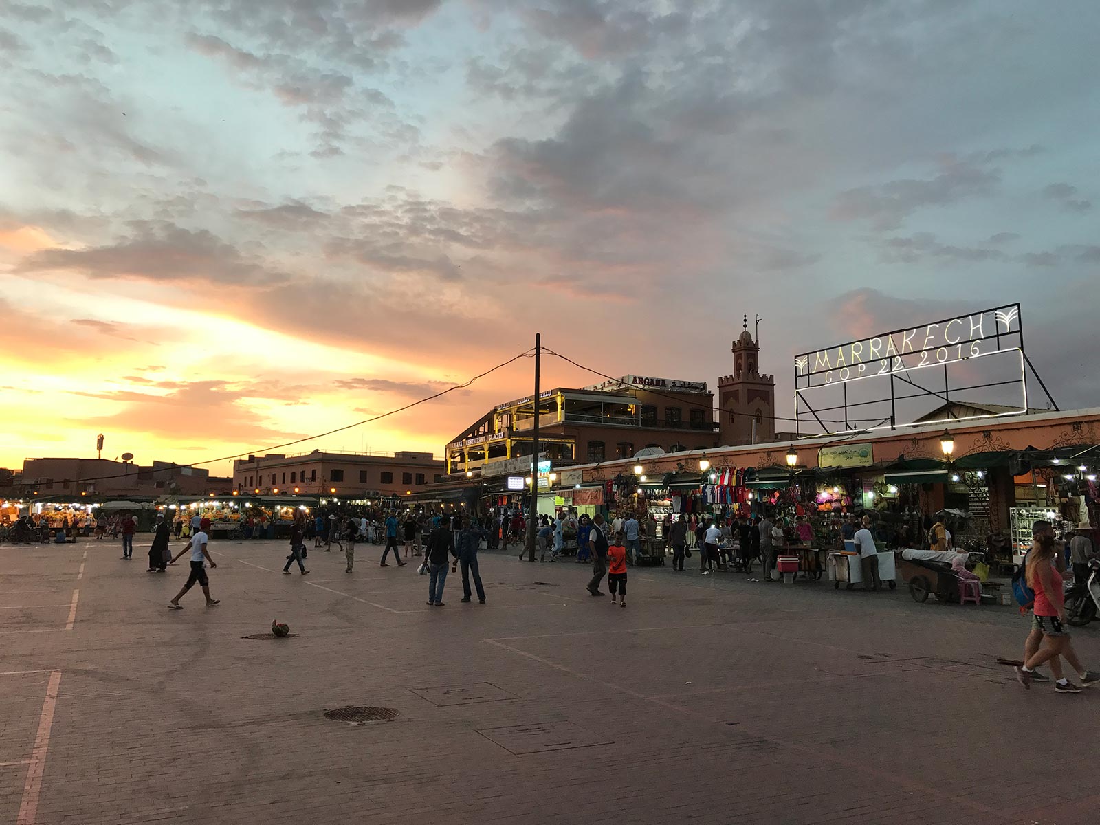 Sunset at the market in Marrakesh, Morocco. Being attacked by a man with a snake